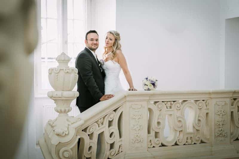 Eine Braut und ein Bräutigam stehen auf einer Treppe.
