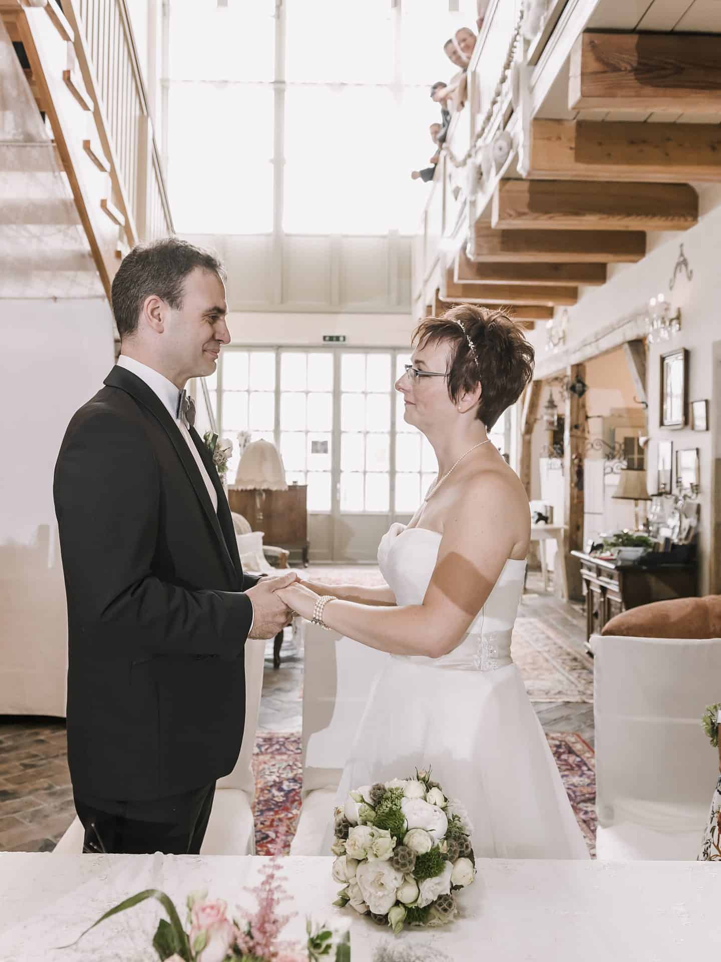 Eine Braut und ein Bräutigam stehen nebeneinander in einem Raum.
