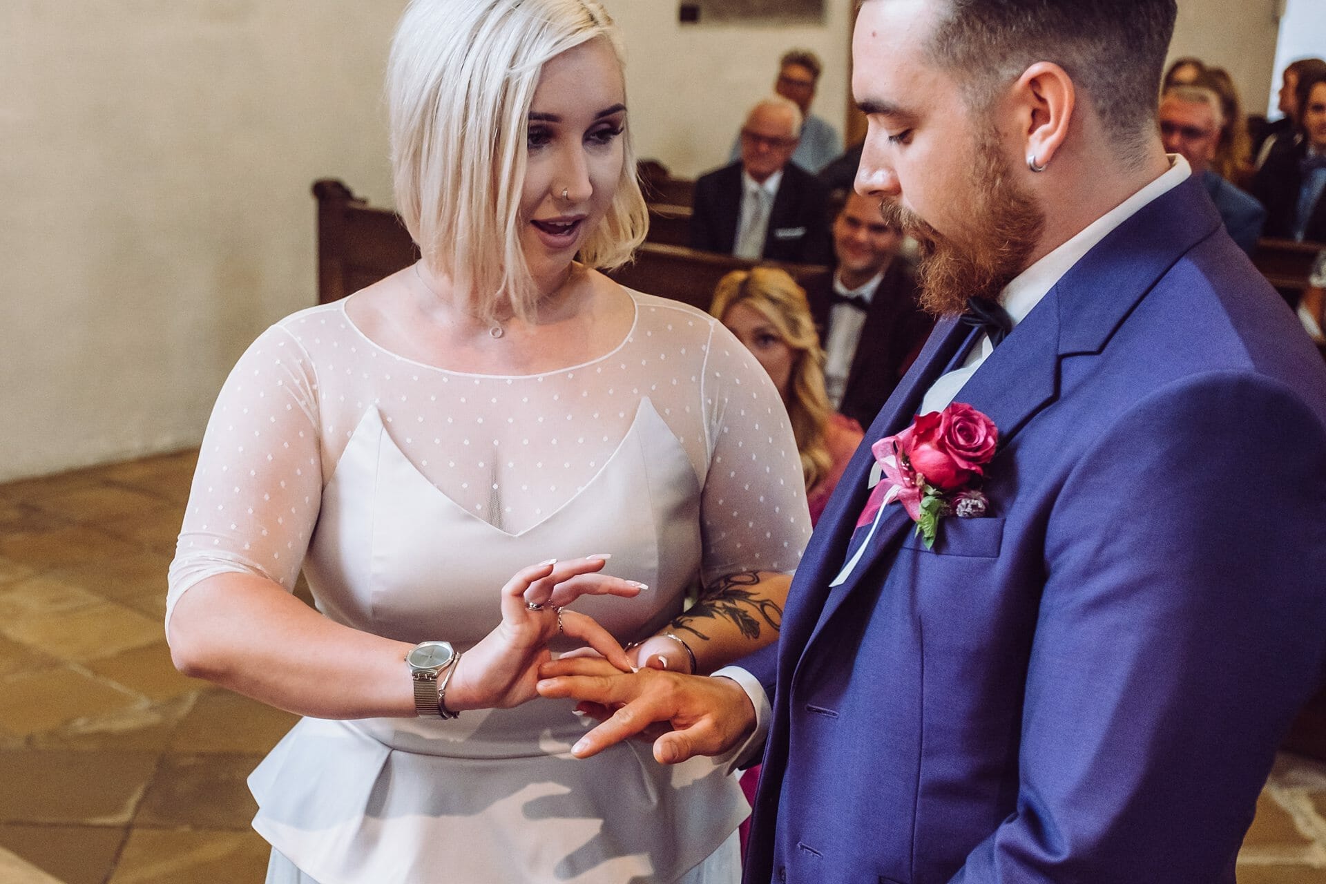 Eine Braut und ein Bräutigam tauschen ihre Eheringe in einer Kirche aus.